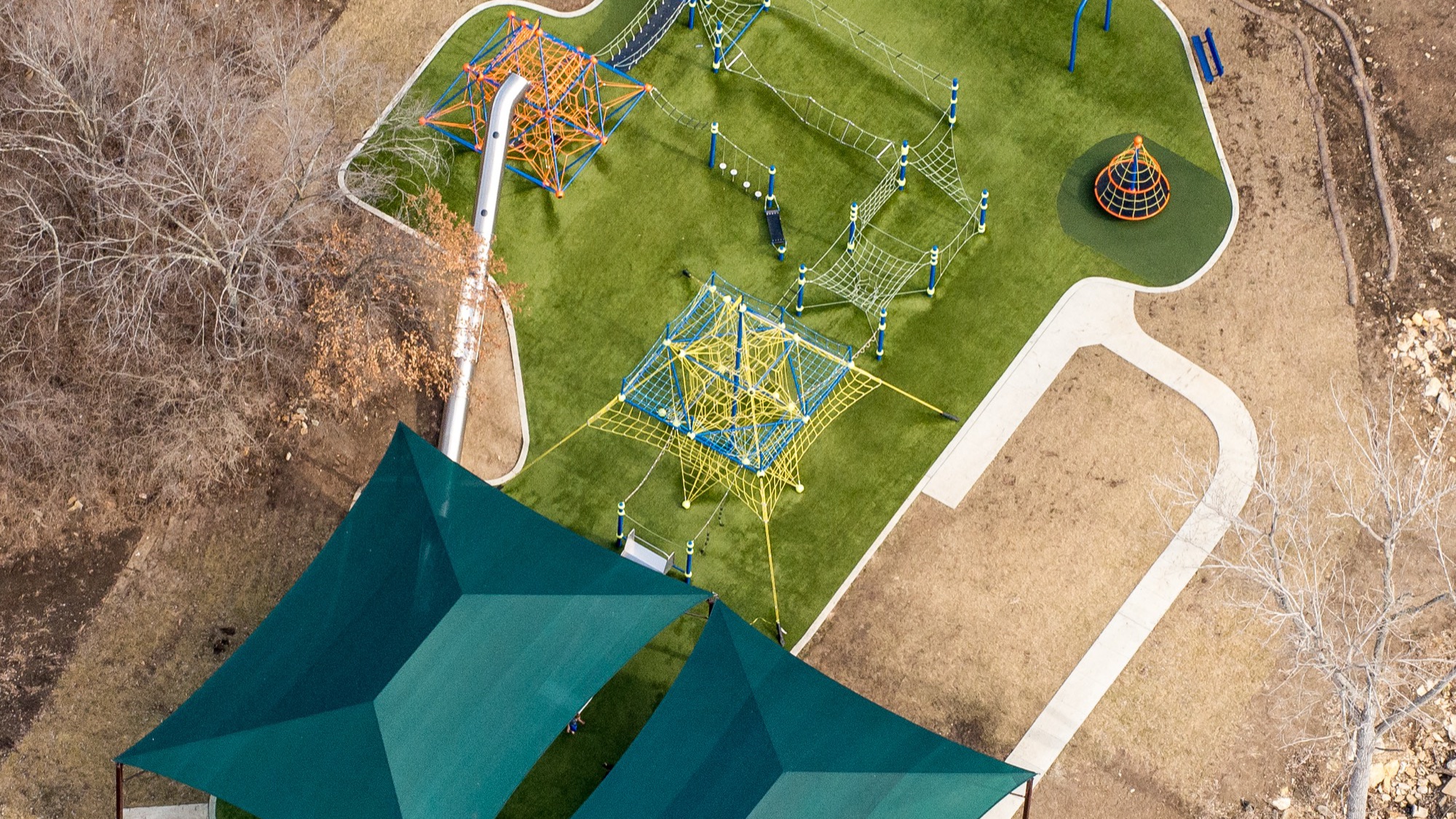 Park and municipal shade structures over a double hip canopy at a public park