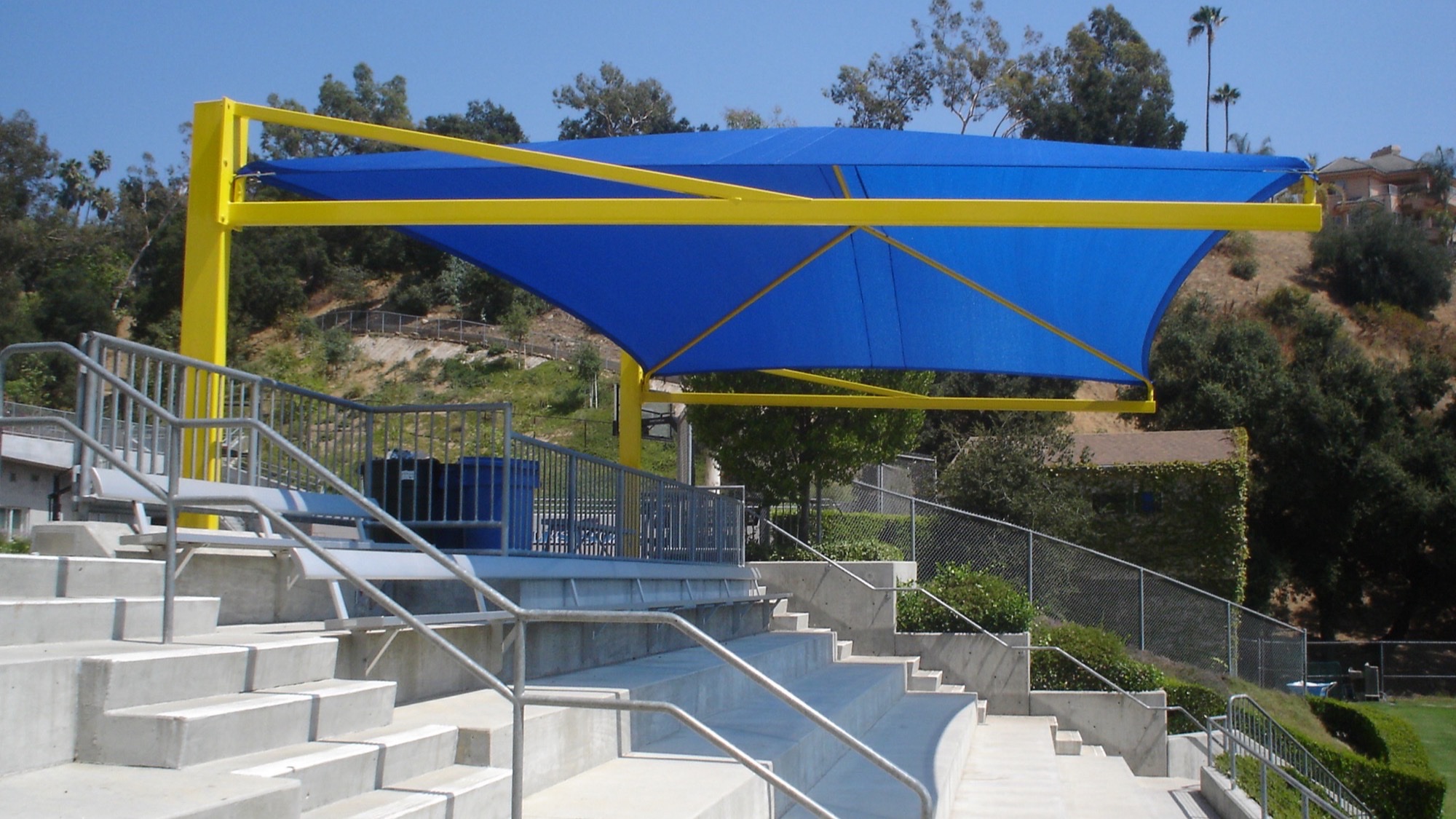 Cantilever vs four-post shade structures comparison over bleacher seating