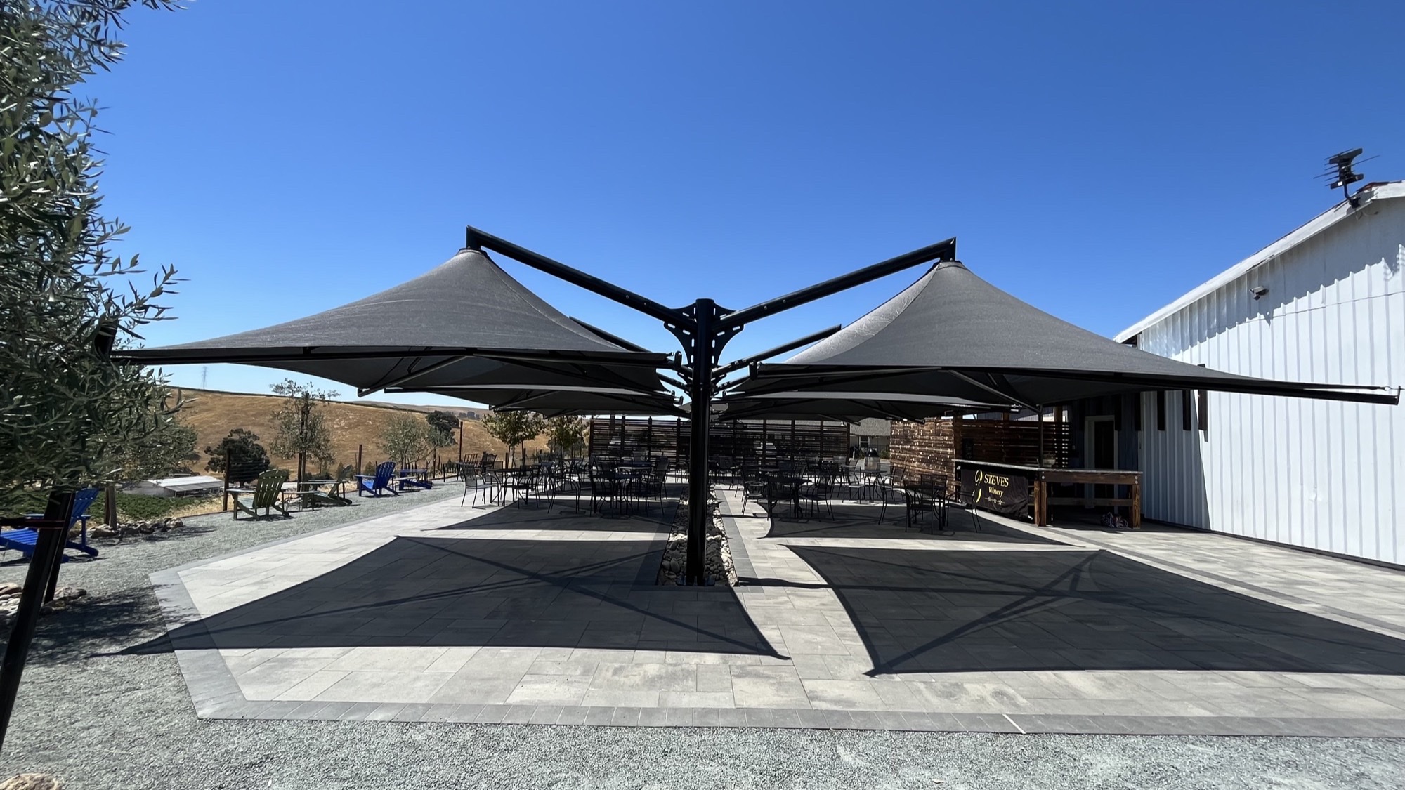 Commercial patio umbrellas shading dining tables on a winery patio