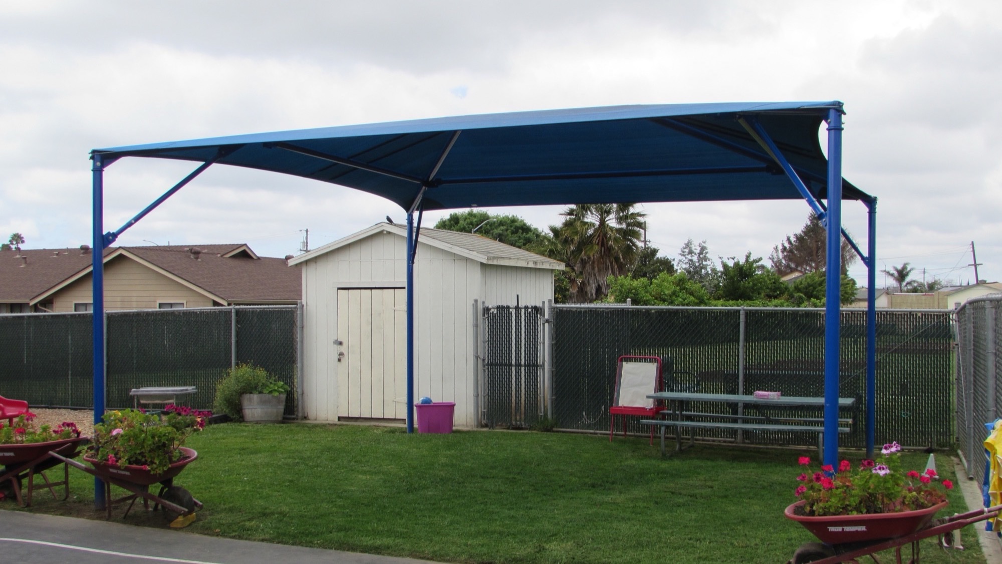 Shade structure installation during the school year on an active campus