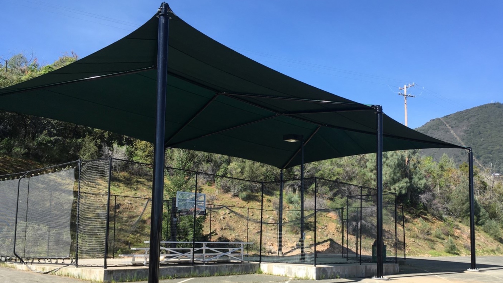 Archery Range Shade Structures Continuous ridge archery range shade structure over a long shooting line