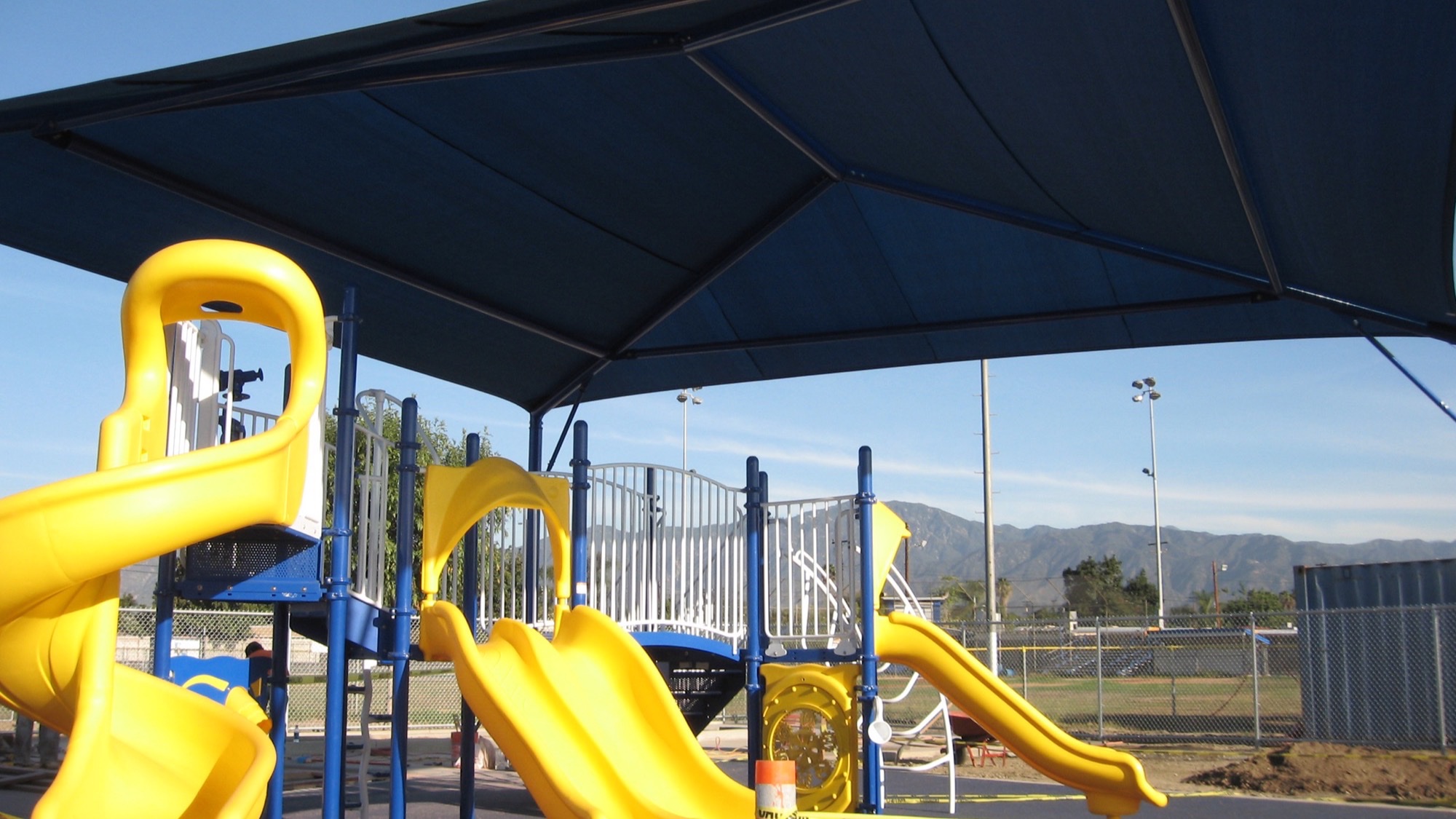 Navy shade structure fabric color over a school playground illustrating shade fabric colors for schools