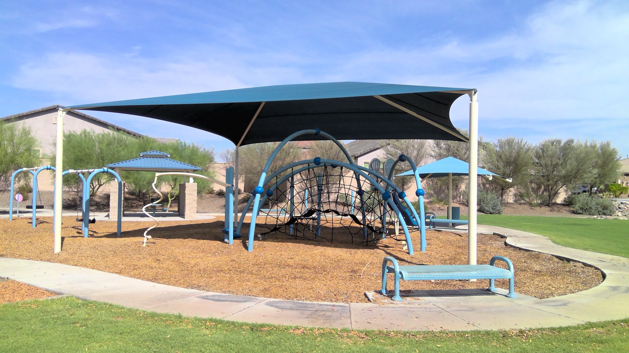Shade structures for RV parks and campgrounds covering a pavilion and playground common area