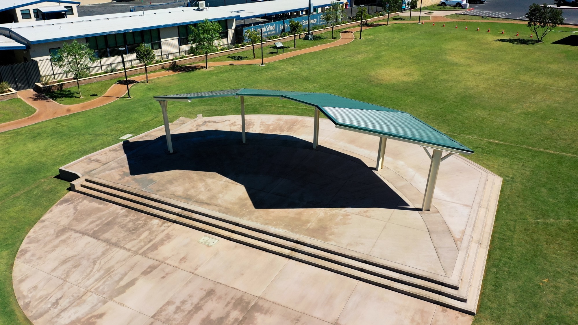 Turnkey Shade Structure Installation Turnkey shade structure installation: completed commercial canopy on a finished concrete plaza at a school campus